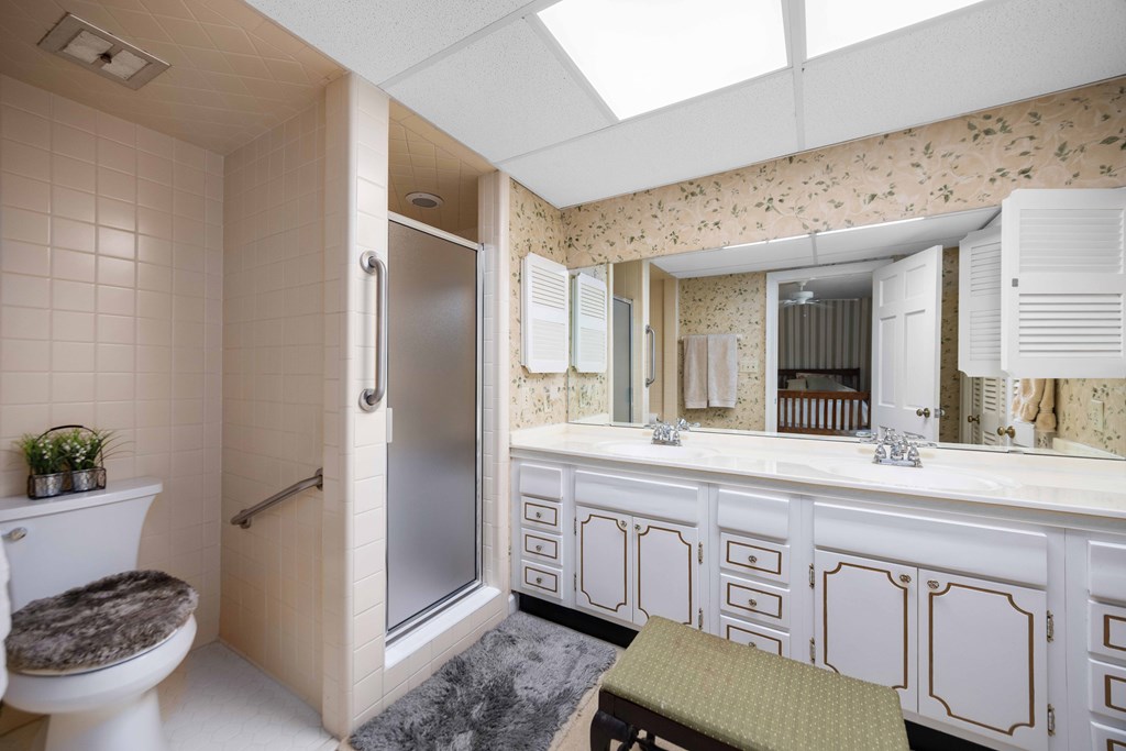 13965 Cross Creek Road Upatoi, GA 31829 - Photo 29 of 44 a spacious bathroom with a granite countertop sink and a mirror