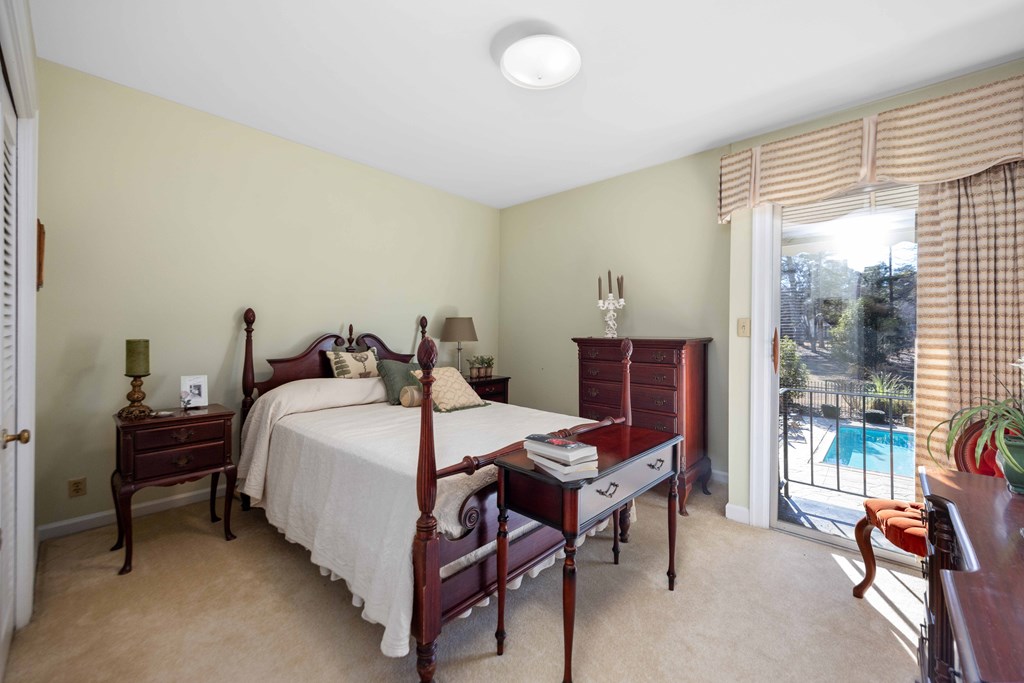 13965 Cross Creek Road Upatoi, GA 31829 - Photo 33 of 44 a bed room with a bed and a chair