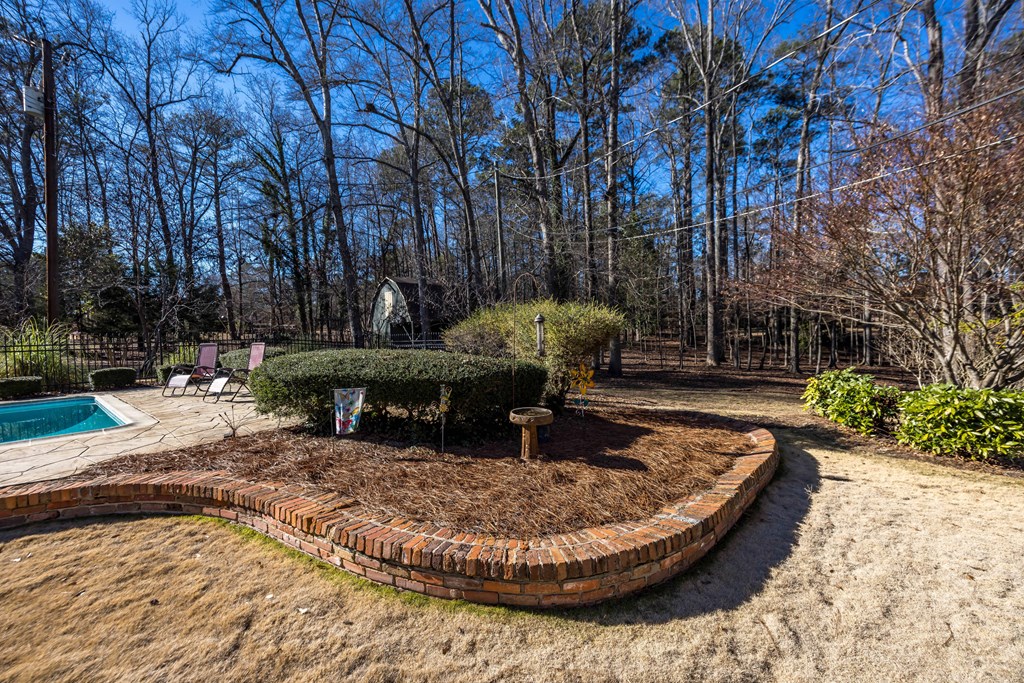 13965 Cross Creek Road Upatoi, GA 31829 - Photo 37 of 44 a view of a swimming pool with sitting area