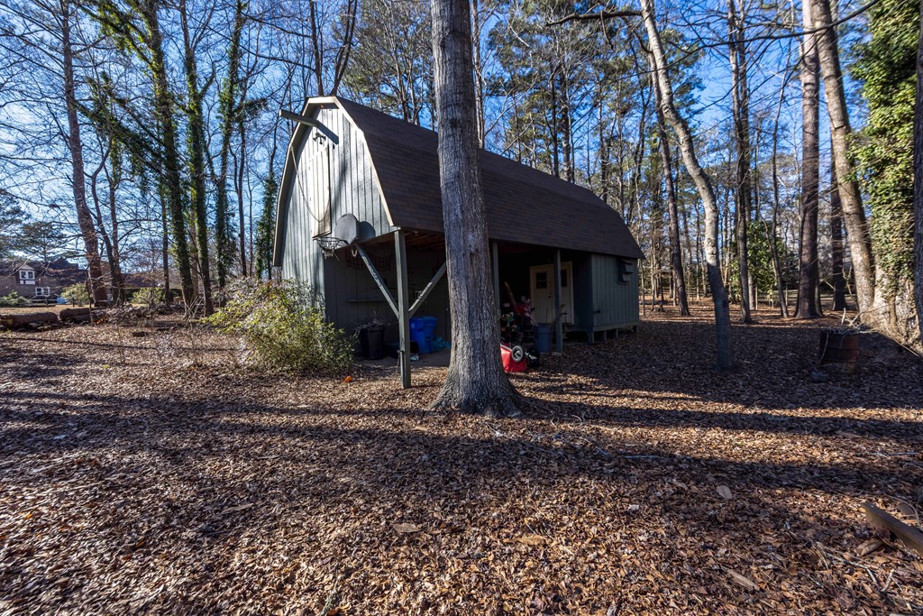 13965 Cross Creek Road Upatoi, GA 31829 - Photo 40 of 44 a view of a barn in the middle of a yard