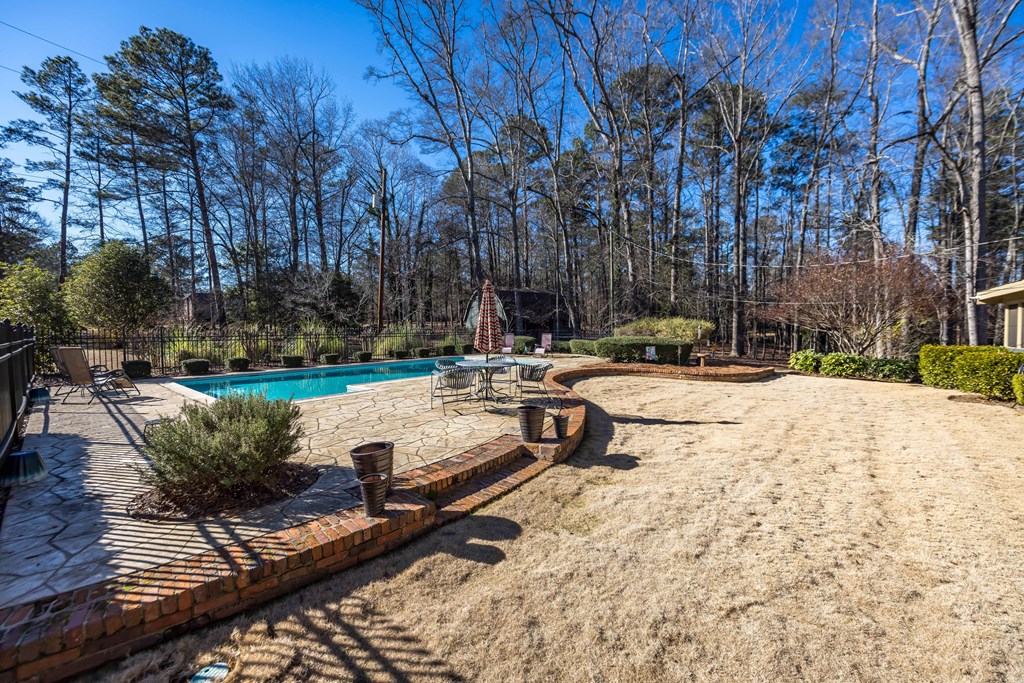 13965 Cross Creek Road Upatoi, GA 31829 - Photo 5 of 44 a view of swimming pool with chairs and trees