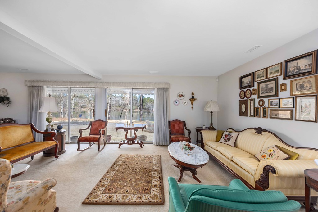 13965 Cross Creek Road Upatoi, GA 31829 - Photo 10 of 44 a living room with furniture potted plant and a large window