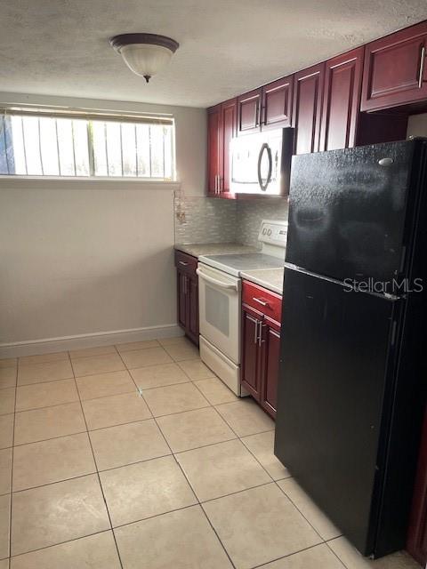 3994 Crayrich Circle, Unit C4 Orlando, FL 32839 - Photo 11 of 14 a kitchen with granite countertop a stove a microwave and a counter top space