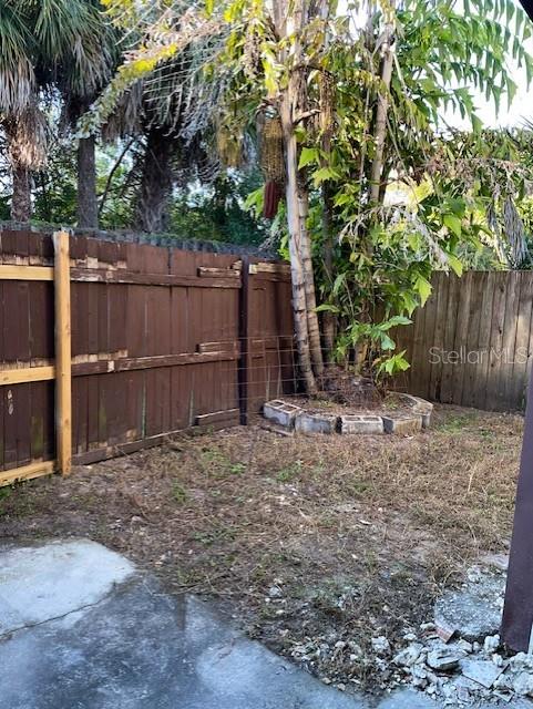 3994 Crayrich Circle, Unit C4 Orlando, FL 32839 - Photo 3 of 14 a backyard of a house with a trees and wooden fence
