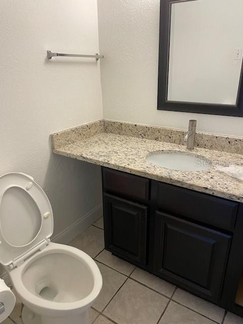 3994 Crayrich Circle, Unit C4 Orlando, FL 32839 - Photo 5 of 14 a bathroom with a granite countertop sink and a mirror