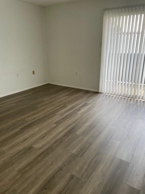 3994 Crayrich Circle, Unit C4 Orlando, FL 32839 - Photo 6 of 14 an empty room with wooden floor and windows