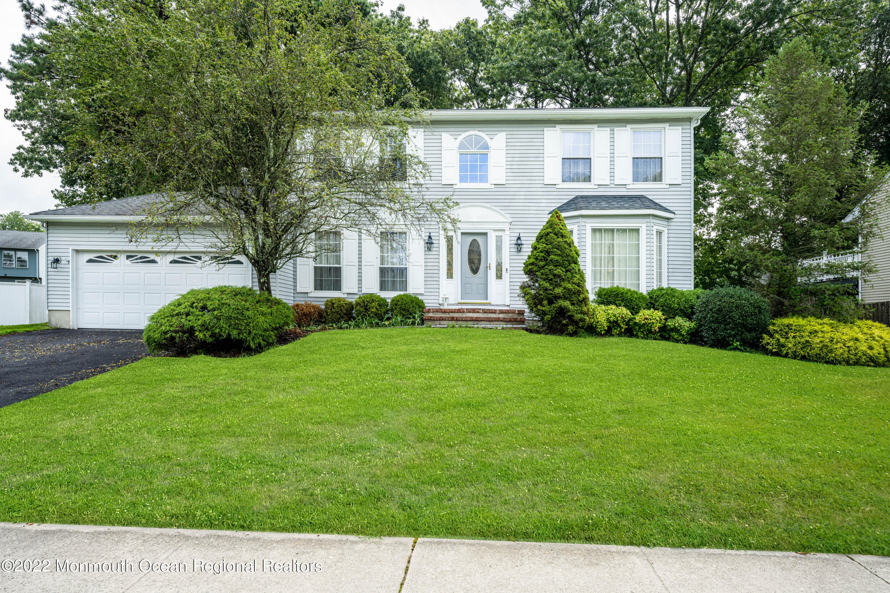9 Metedeconk Road Howell, NJ 07731 - Photo 1 of 25 a front view of a house with a garden