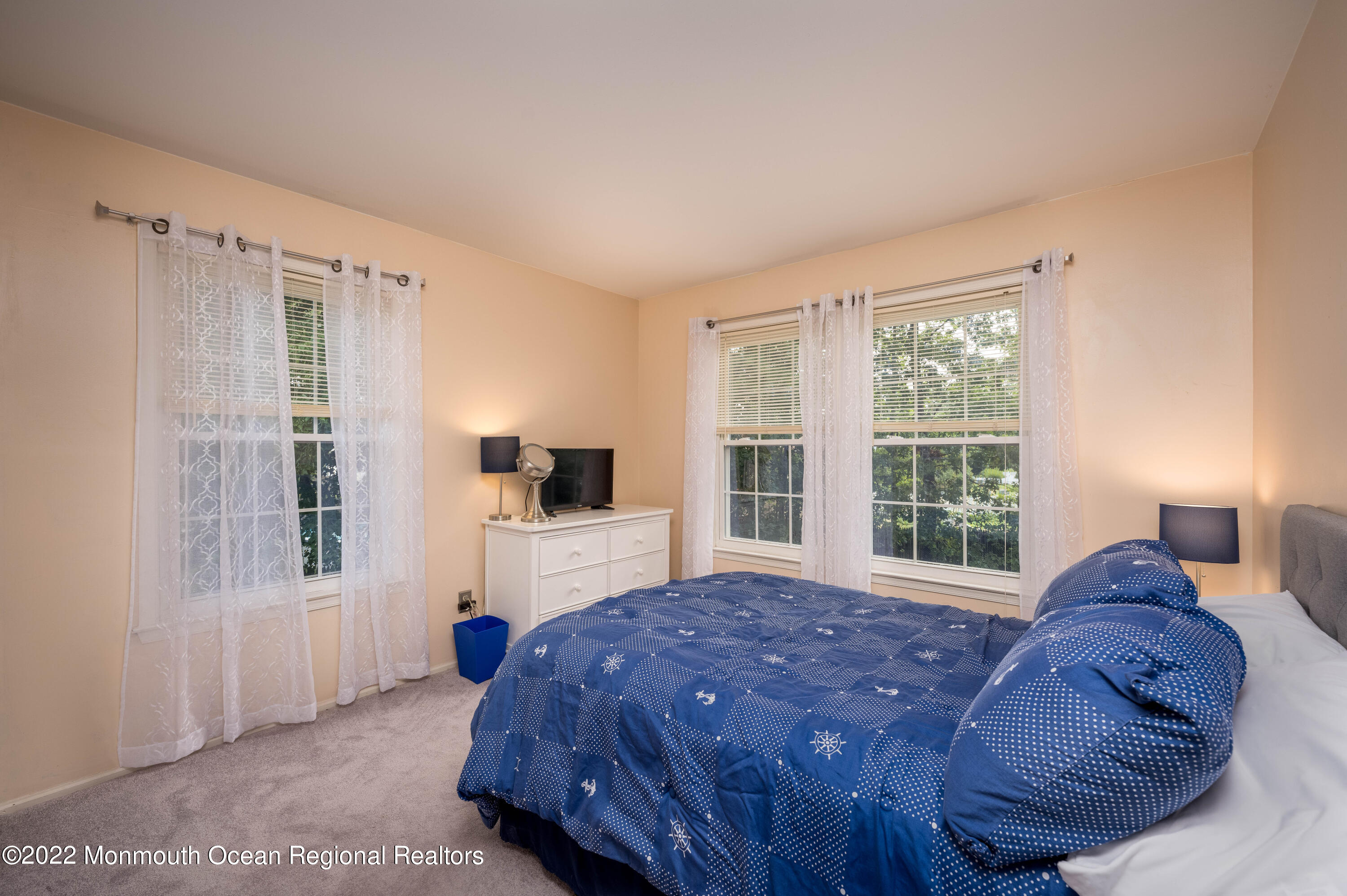 9 Metedeconk Road Howell, NJ 07731 - Photo 15 of 25 a spacious bedroom with a bed and a flat tv screen next to a window