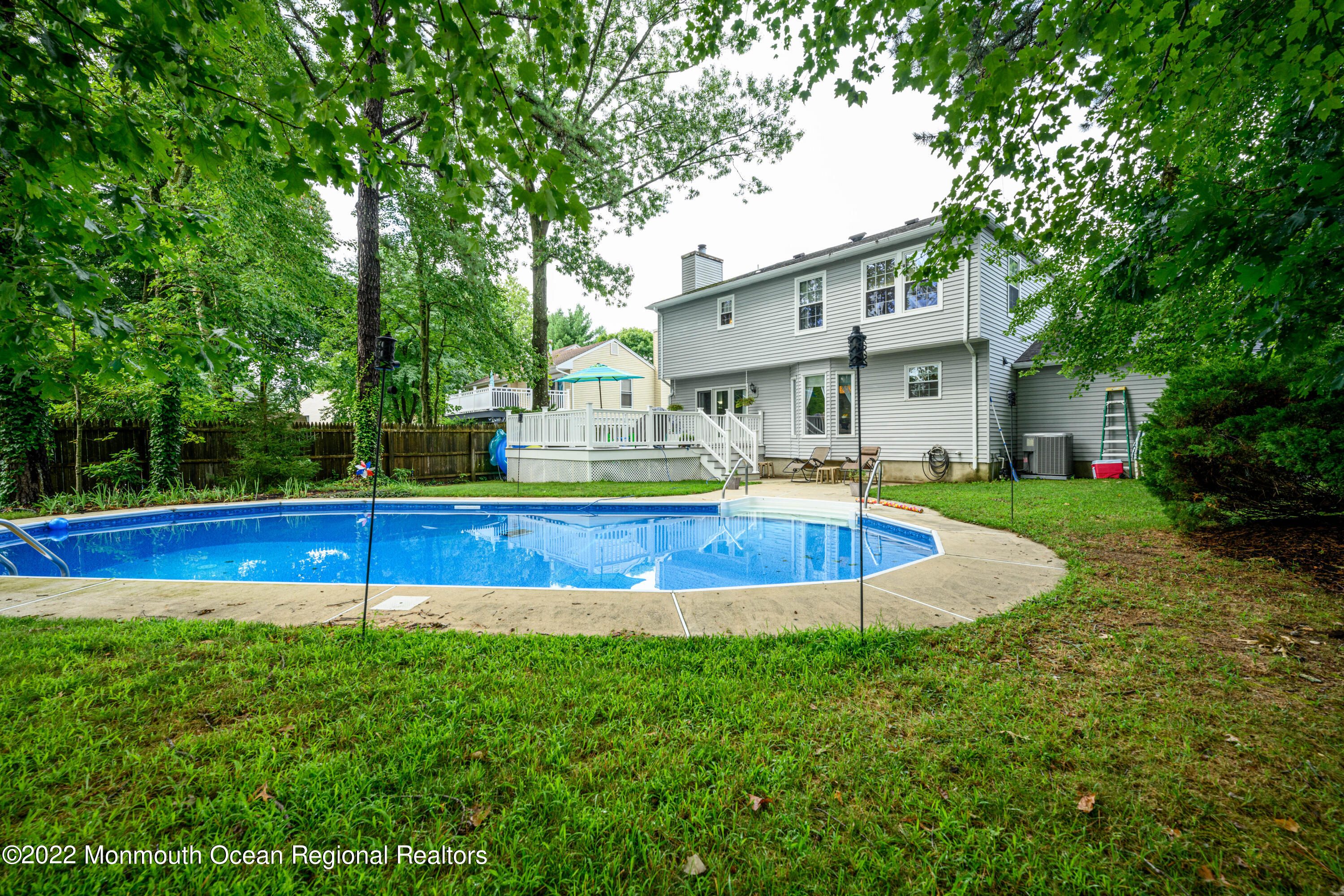 9 Metedeconk Road Howell, NJ 07731 - Photo 18 of 25 a view of a house with swimming pool and yard