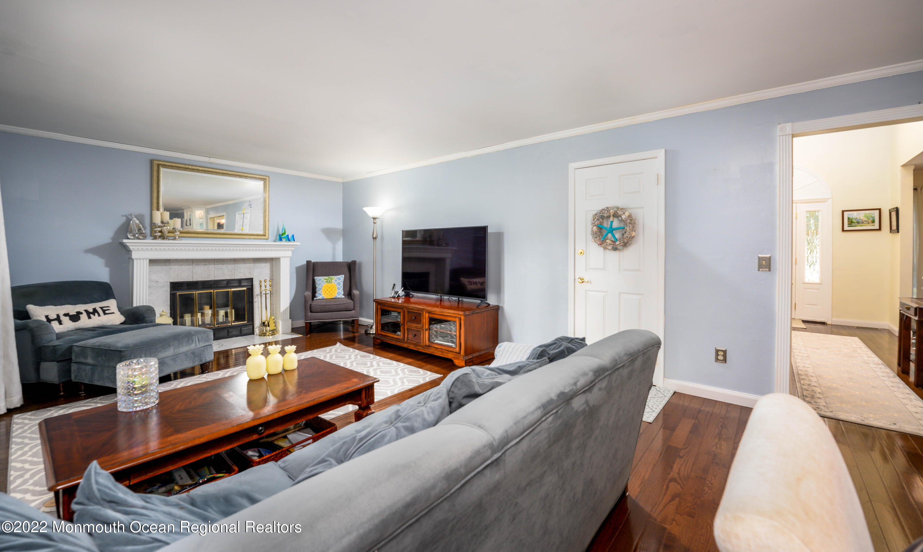 9 Metedeconk Road Howell, NJ 07731 - Photo 8 of 25 a living room with furniture a flat screen tv and a fireplace