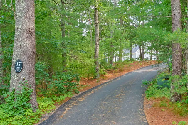 a view of a brick house with a flower garden