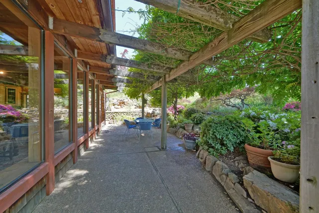 a dining room with furniture and a floor to ceiling window