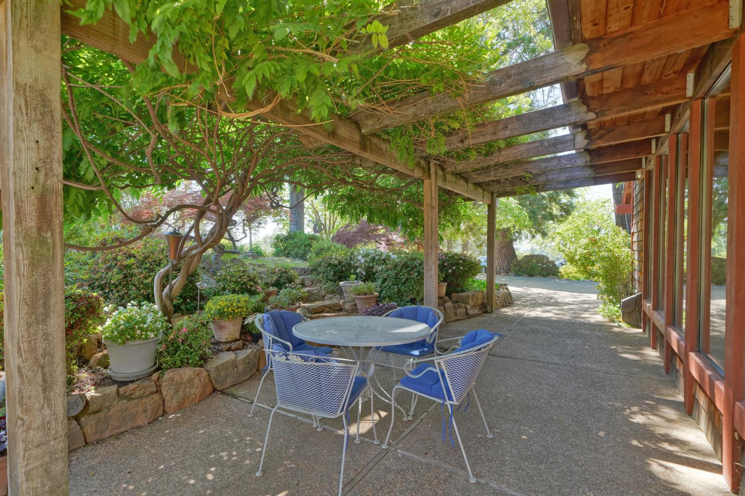 2399 Kingsgate Road Placerville, CA 95667 - Photo 13 of 89 a view of a patio with a table chairs and a potted plant
