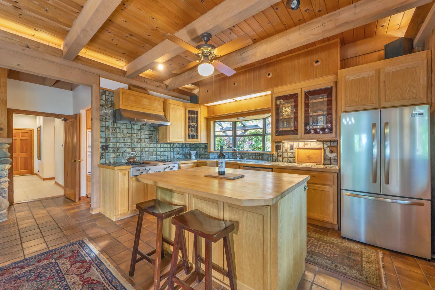 2399 Kingsgate Road Placerville, CA 95667 - Photo 22 of 89 a kitchen with stainless steel appliances granite countertop a sink and a refrigerator
