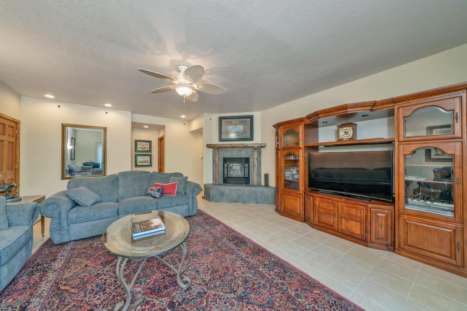 2399 Kingsgate Road Placerville, CA 95667 - Photo 26 of 89 a living room with furniture a flat screen tv and a fireplace