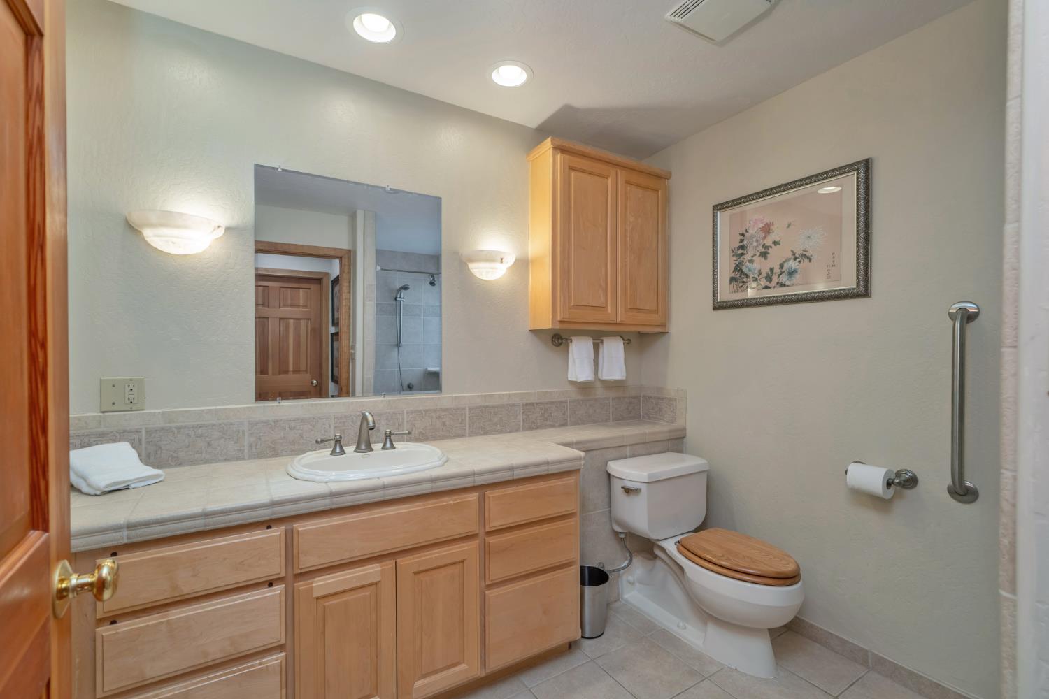 2399 Kingsgate Road Placerville, CA 95667 - Photo 27 of 89 a bathroom with a toilet sink and mirror