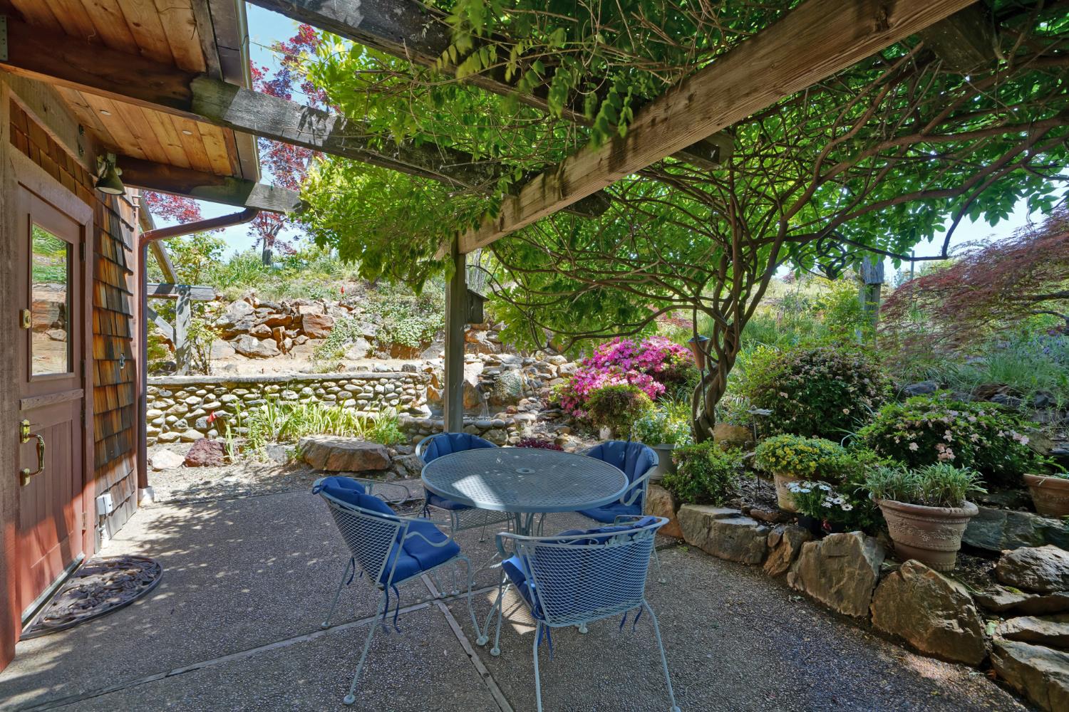 2399 Kingsgate Road Placerville, CA 95667 - Photo 85 of 89 a view of a patio with couches table and chairs and potted plants