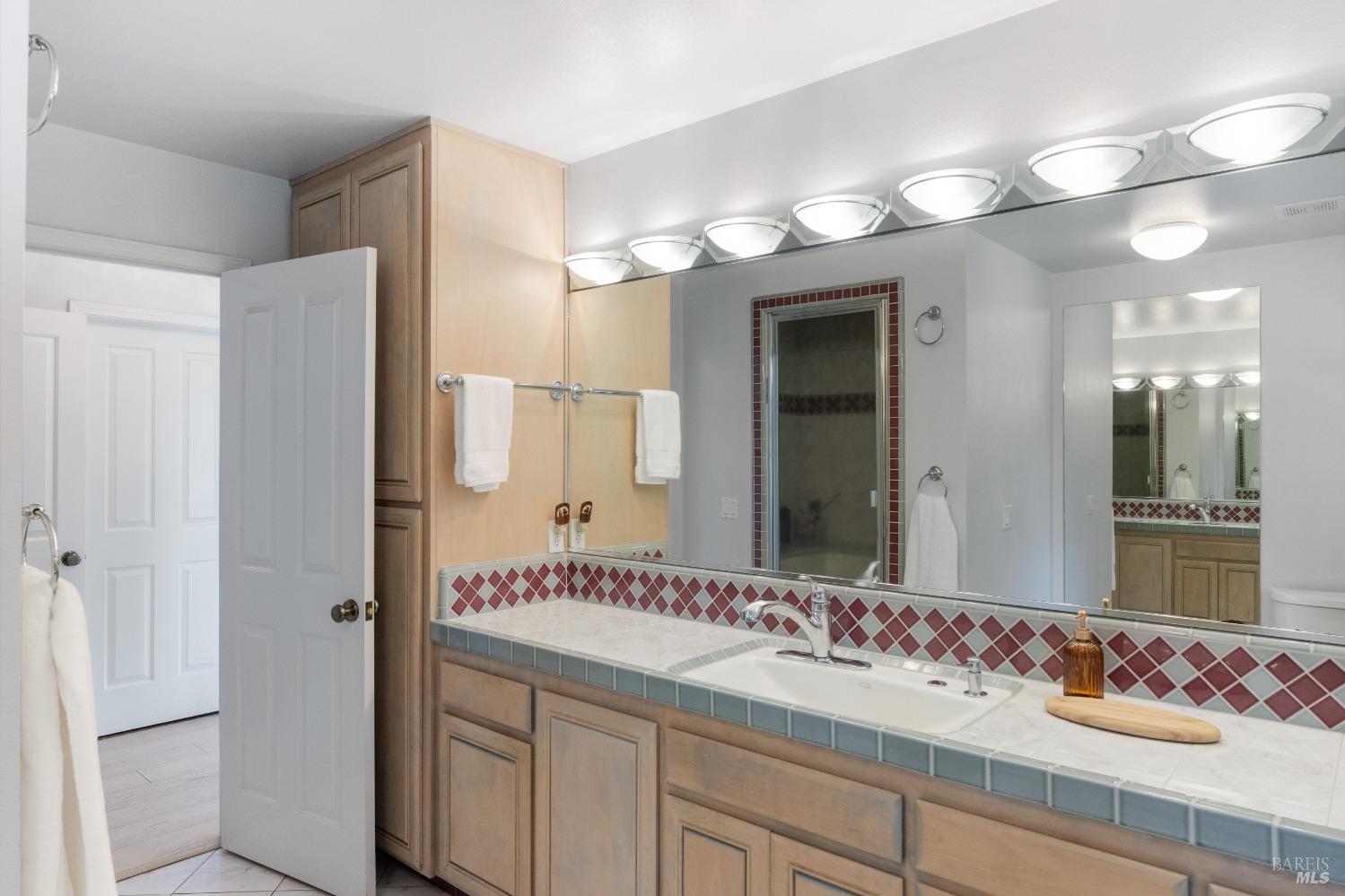 127 Mountain Meadow Lane Santa Rosa, CA 95404 - Photo 13 of 24 a bathroom with a sink and a mirror