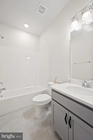 a bathroom with a sink a toilet and a bathtub