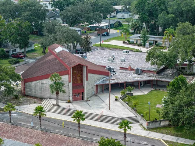 an aerial view of a house with a yard table and chairs