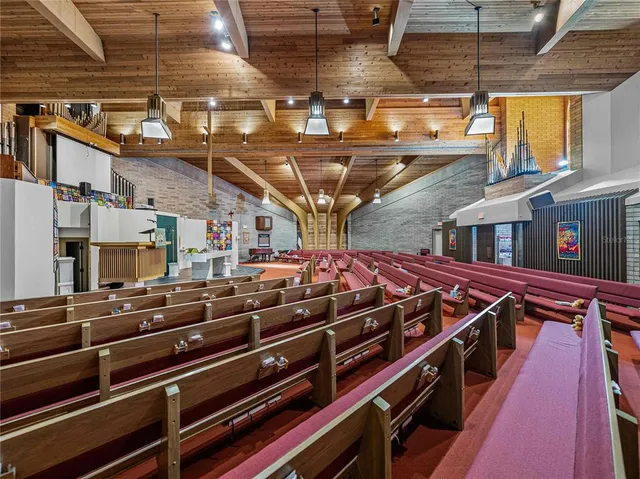 a kitchen with a stove a refrigerator and chairs