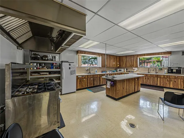 a kitchen with stainless steel appliances granite countertop a sink and a wooden floors