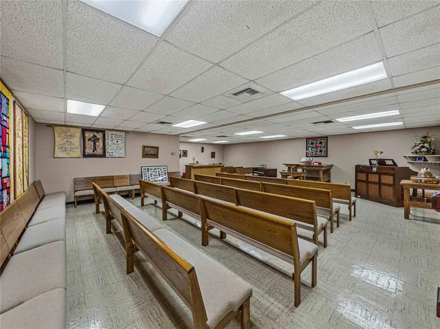 a living room with a table tennis table and a rug