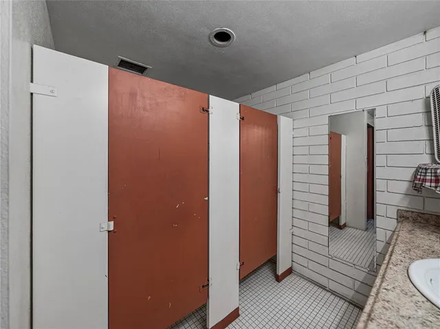 a view of a walk in closet with clothes and shoes