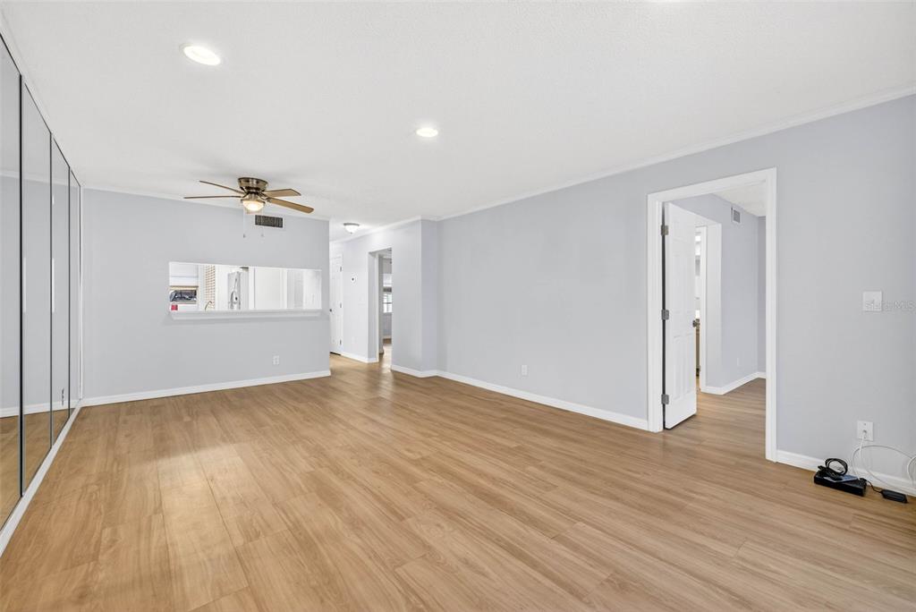 5197 Silent Loop, Unit 124 New Port Richey, FL 34652 - Photo 18 of 55 an empty room with wooden floor and windows