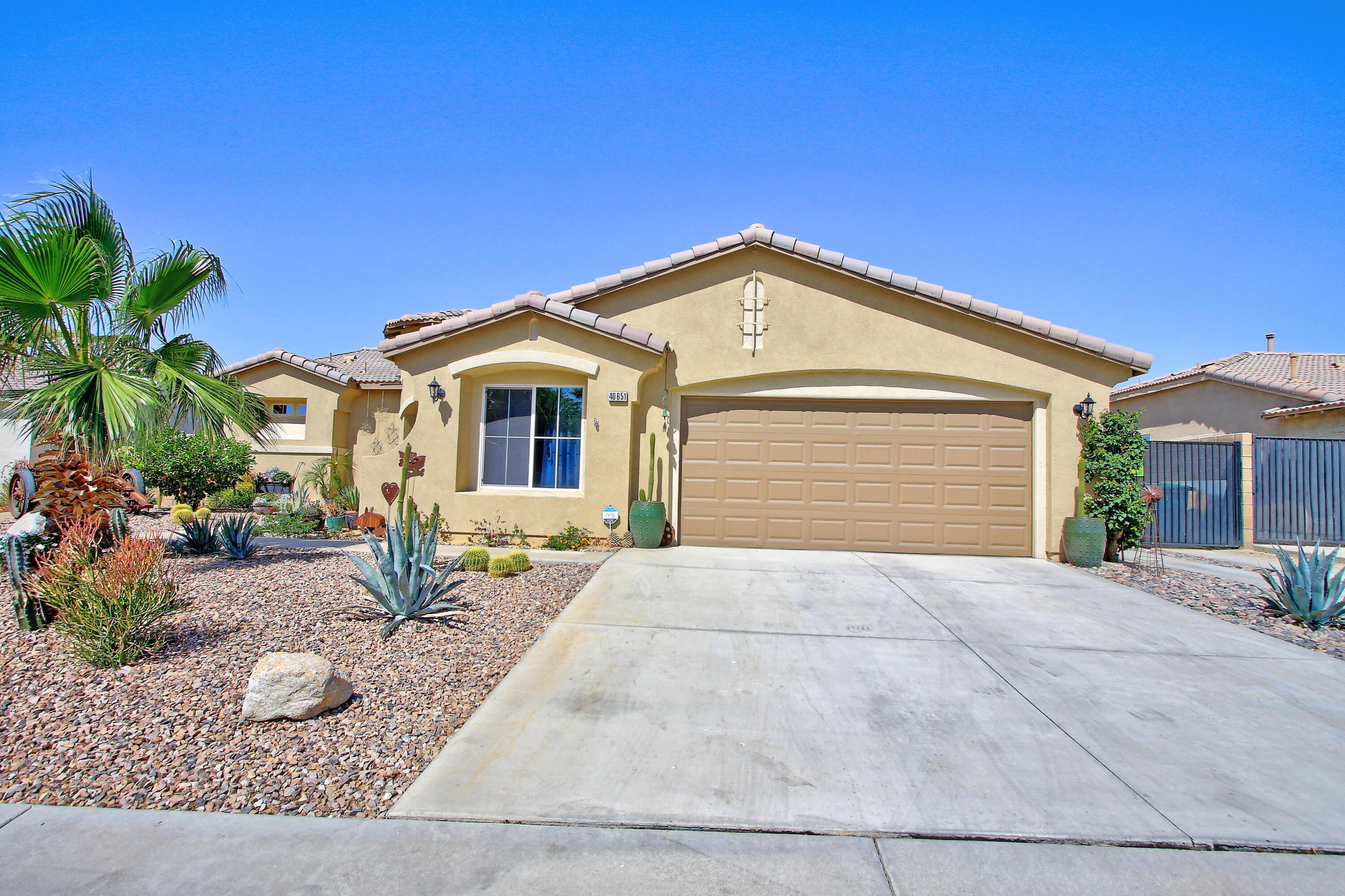 40651 Morris Street Indio, CA 92203 - Photo 1 of 47 a front view of a house with garden