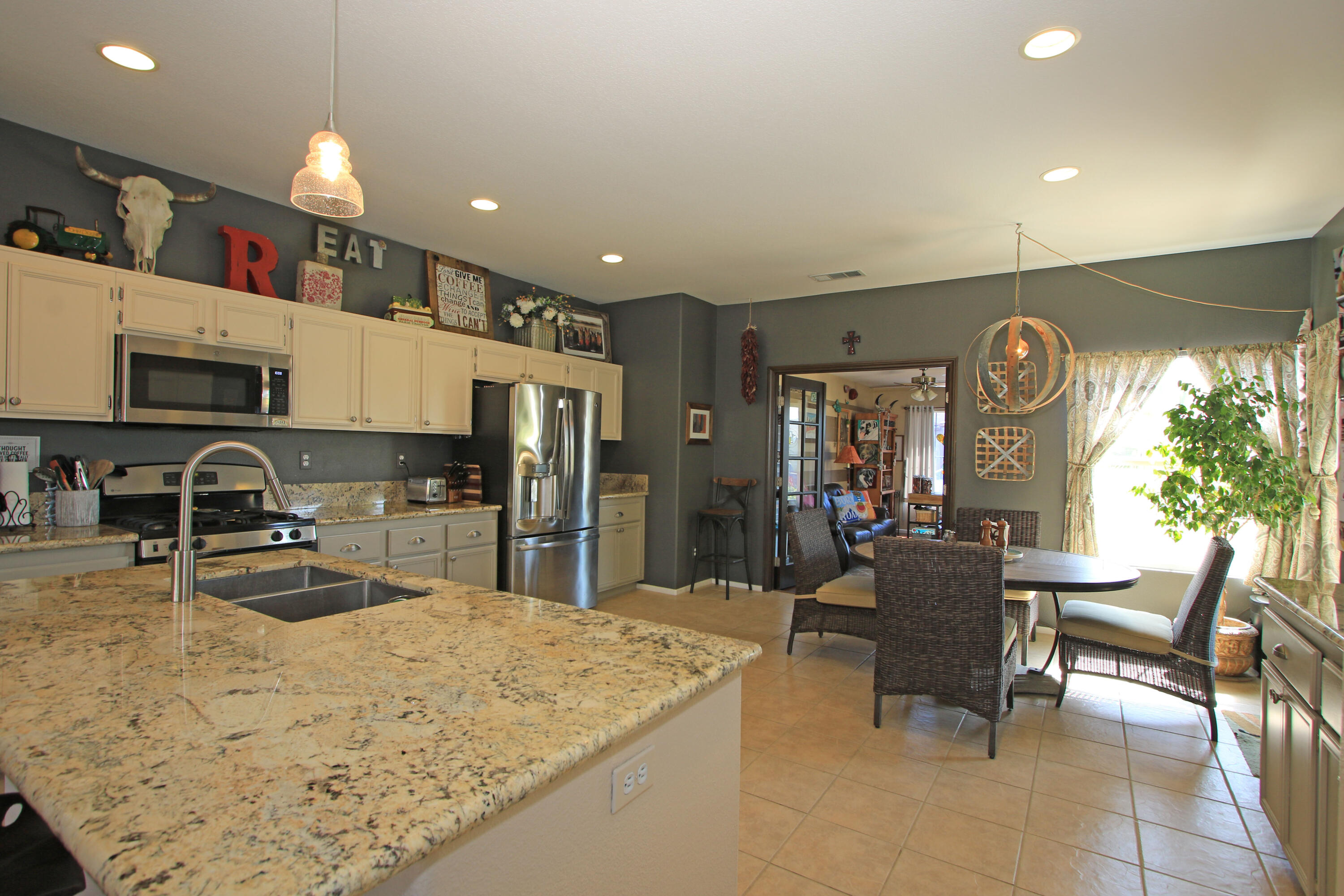 40651 Morris Street Indio, CA 92203 - Photo 11 of 47 a kitchen with stainless steel appliances granite countertop sink microwave and cabinets
