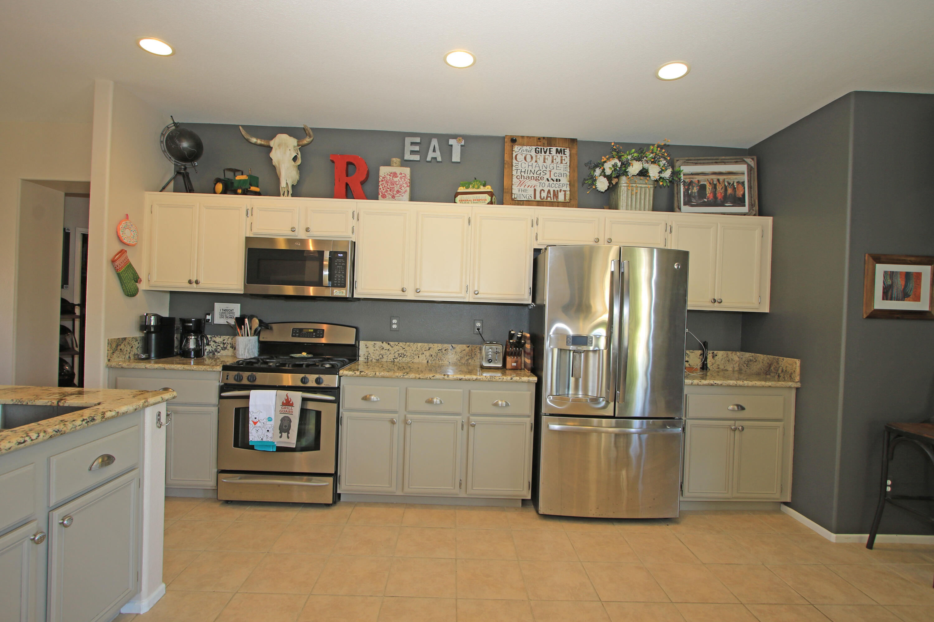 40651 Morris Street Indio, CA 92203 - Photo 12 of 47 a kitchen with stainless steel appliances a refrigerator sink and white cabinets
