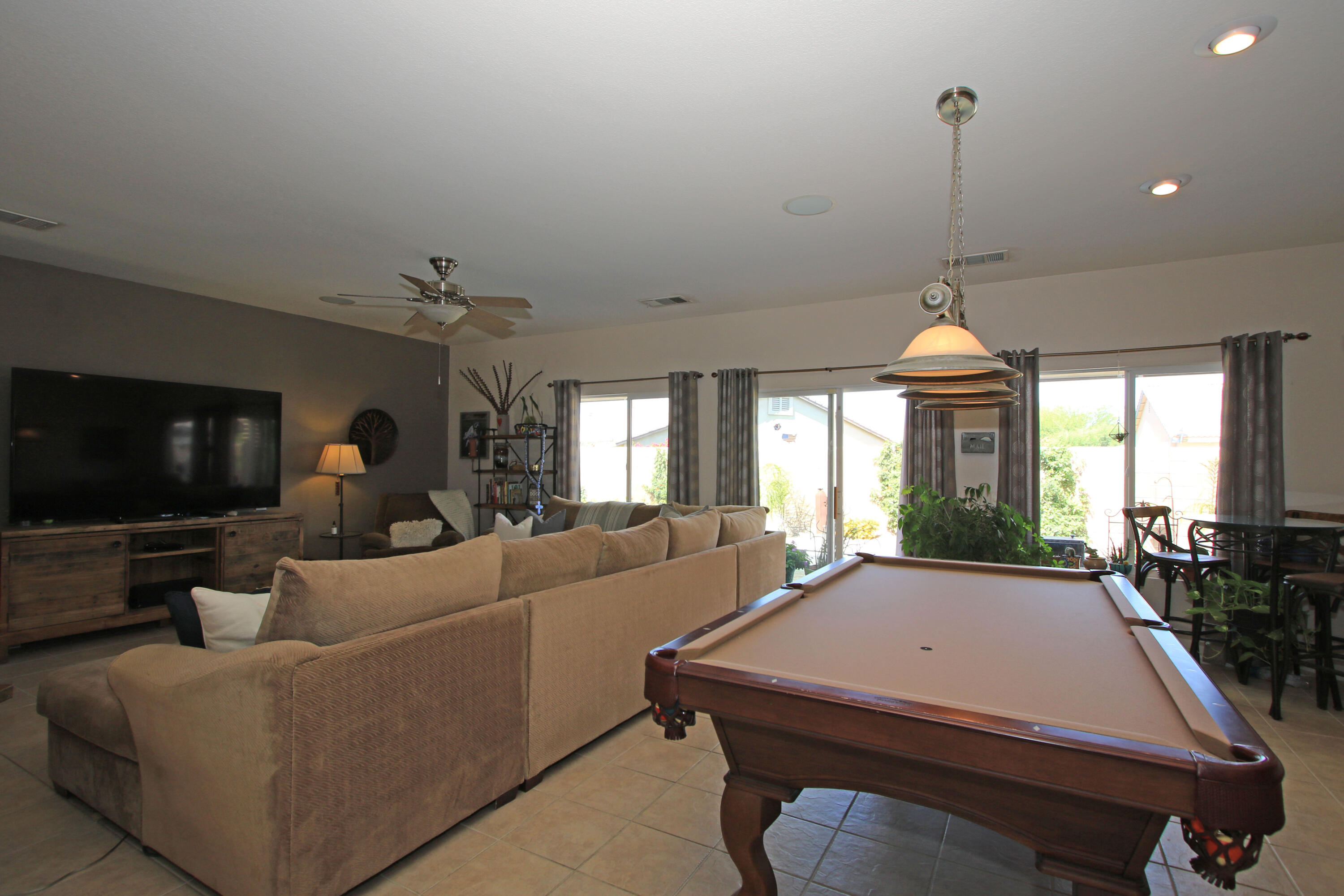 40651 Morris Street Indio, CA 92203 - Photo 18 of 47 a living room with furniture a flat screen tv and a large window