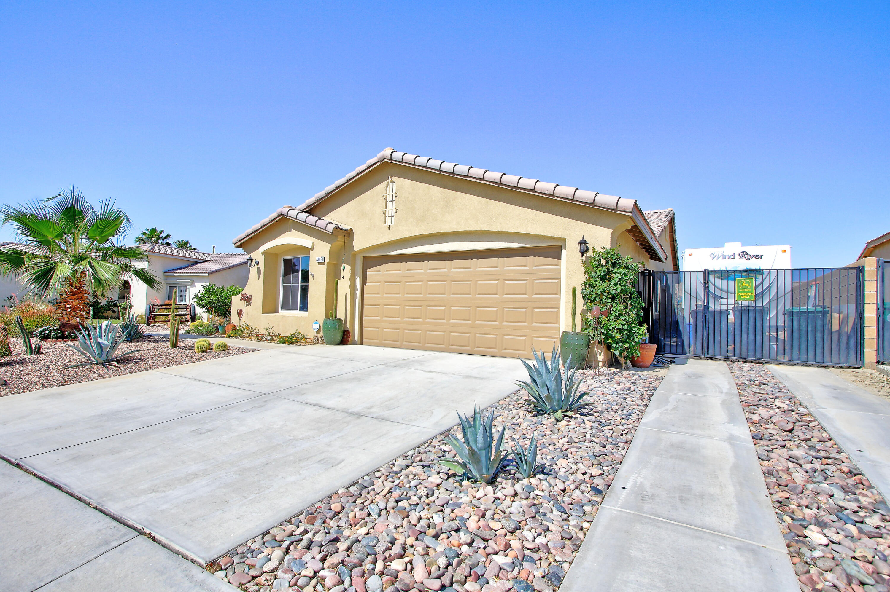 40651 Morris Street Indio, CA 92203 - Photo 2 of 47 a front view of a house with a yard