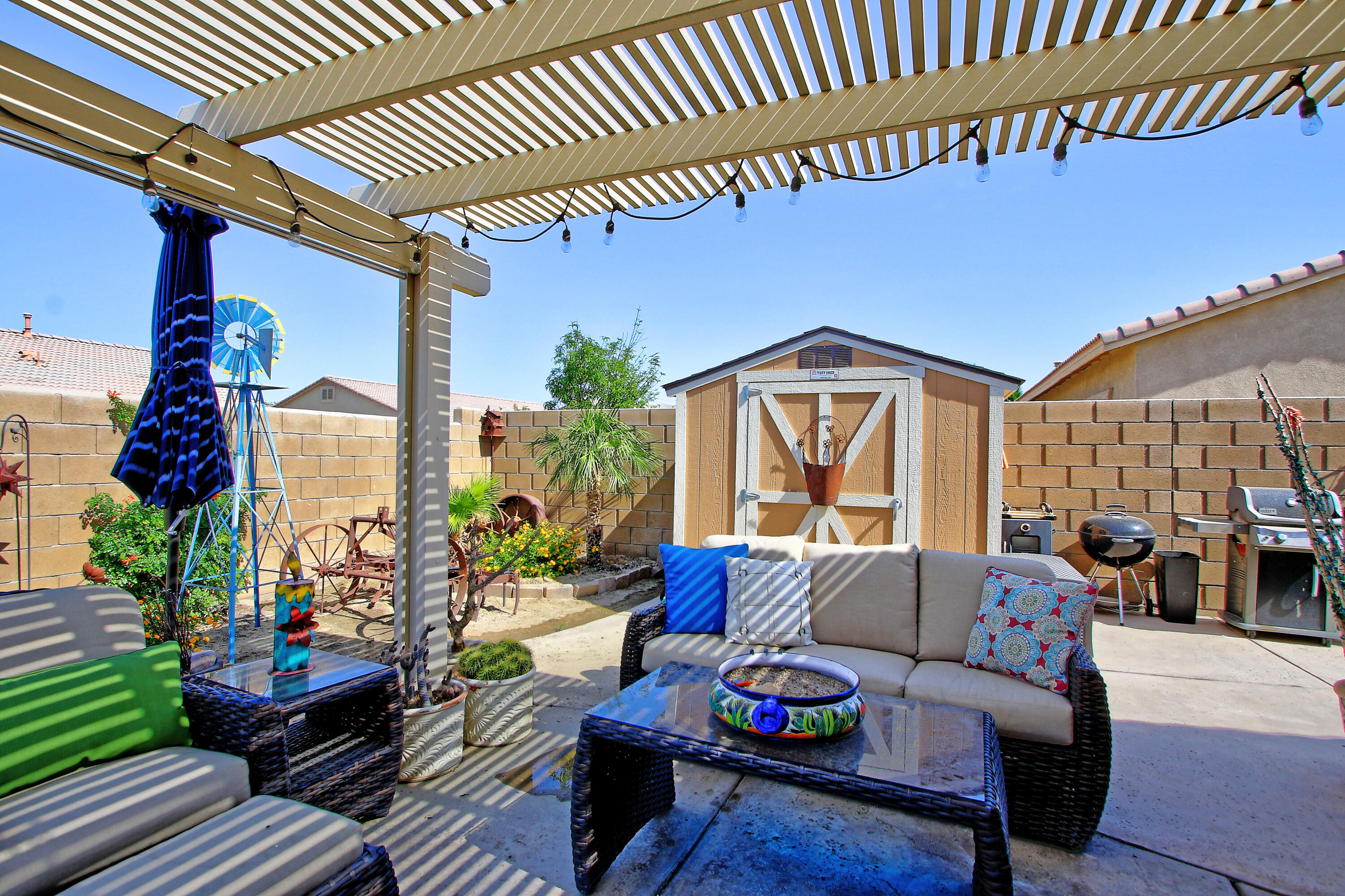 40651 Morris Street Indio, CA 92203 - Photo 33 of 47 a outdoor living space with furniture and a potted plant