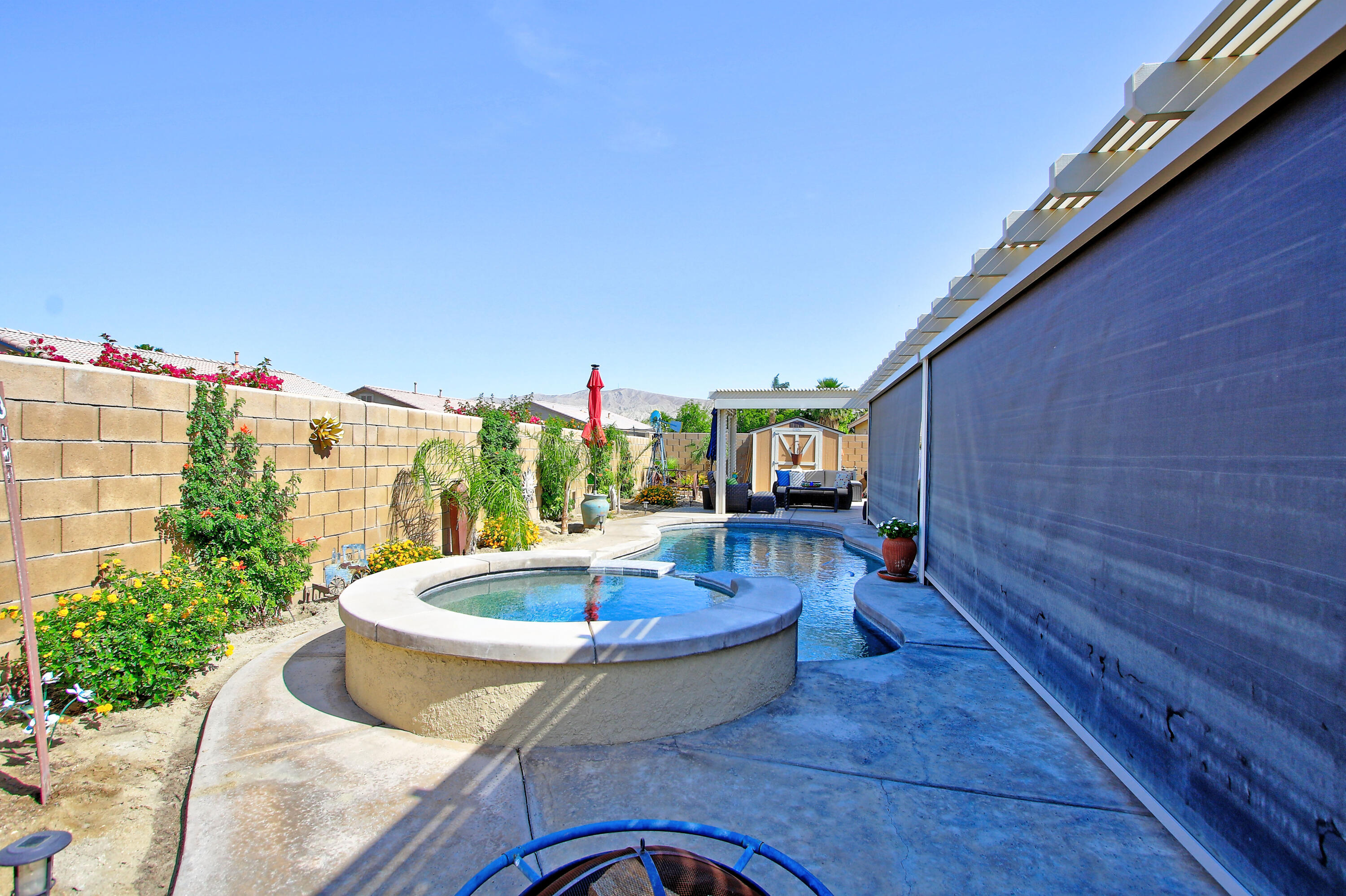 40651 Morris Street Indio, CA 92203 - Photo 43 of 47 a view of swimming pool with outdoor seating and plants