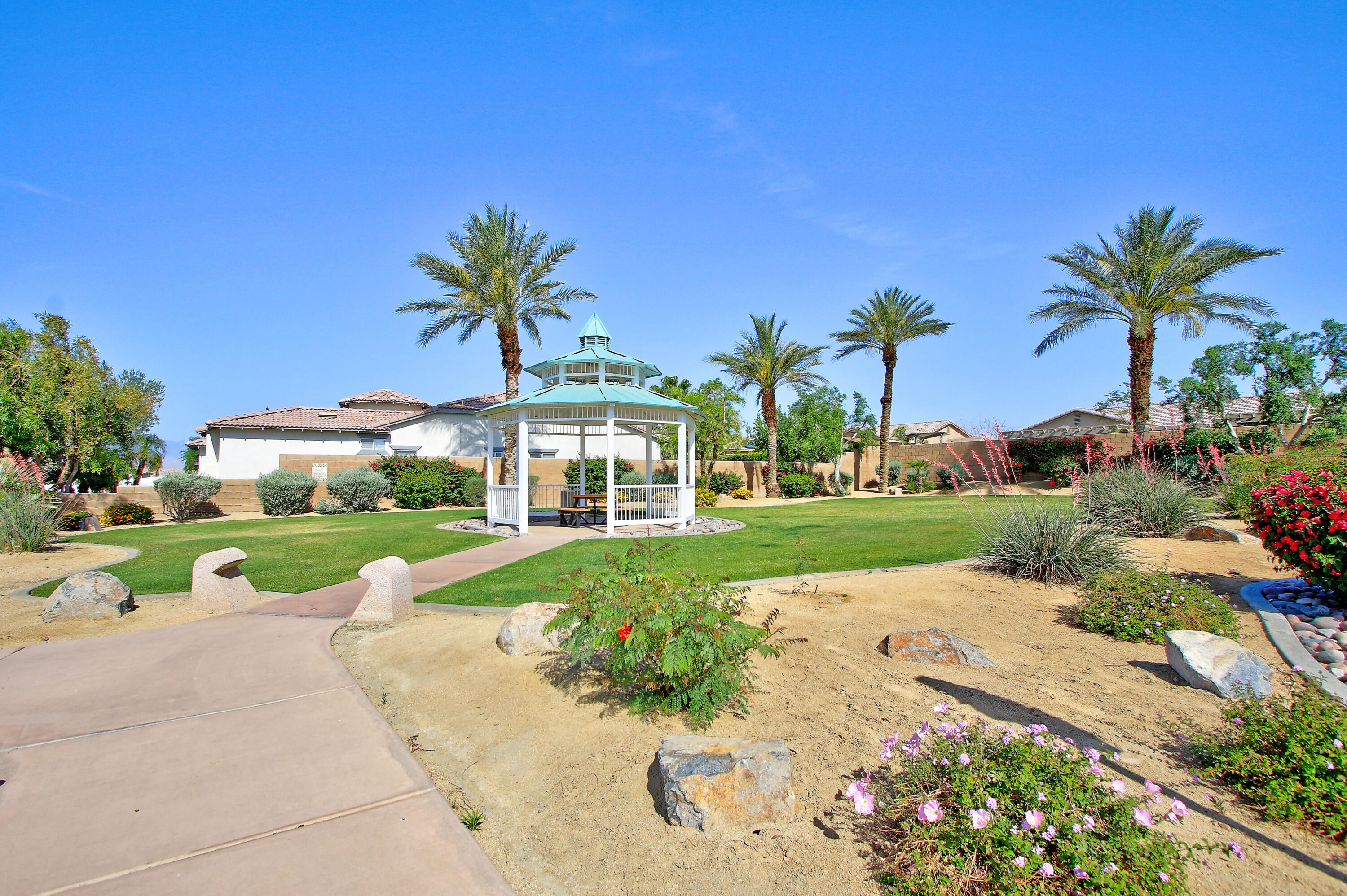 40651 Morris Street Indio, CA 92203 - Photo 47 of 47 a view of a garden with a building in the background