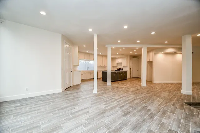 a view of large kitchen with stainless steel appliances cabinets and wooden floor