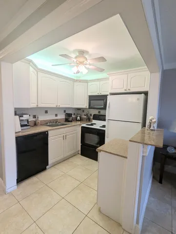 a kitchen with a cabinets and white appliances