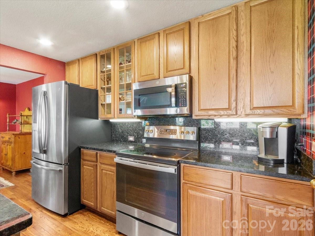 121 Ivy Ridge Road Burnsville, NC 28714 - Photo 13 of 48 a kitchen with stainless steel appliances granite countertop a refrigerator and a sink