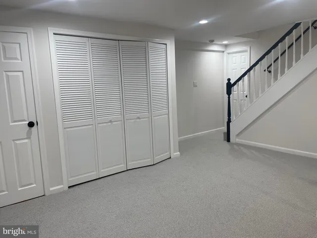 a view of an empty room with stairs