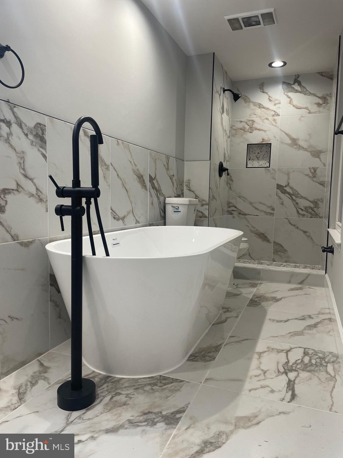 7927 Red Jacket Way Jessup, MD 20794 - Photo 8 of 20 a white bath tub sitting in a bathroom