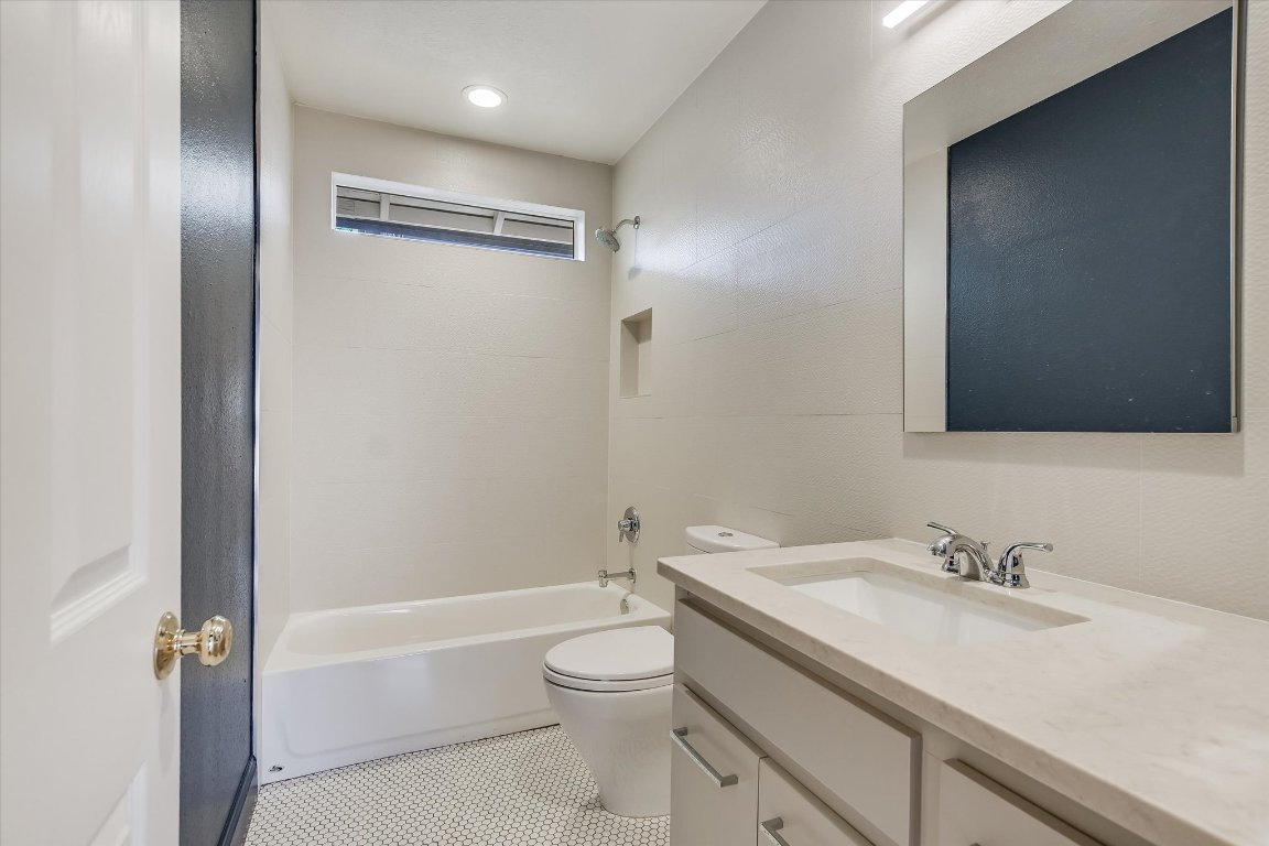 1208 East 13th Street Austin, TX 78702 - Photo 11 of 12 Full bath with vanity, washtub / shower combination, and light tile patterned floors