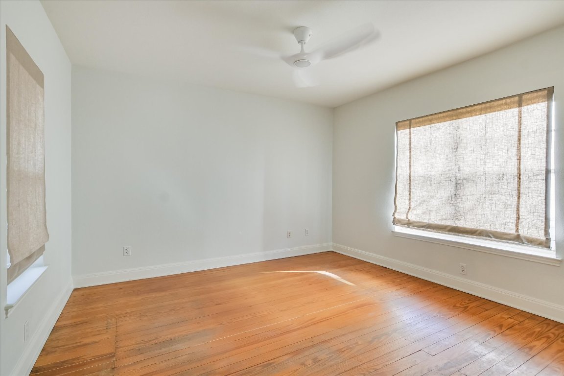 1208 East 13th Street Austin, TX 78702 - Photo 8 of 12 Unfurnished room featuring light wood-type flooring and a ceiling fan