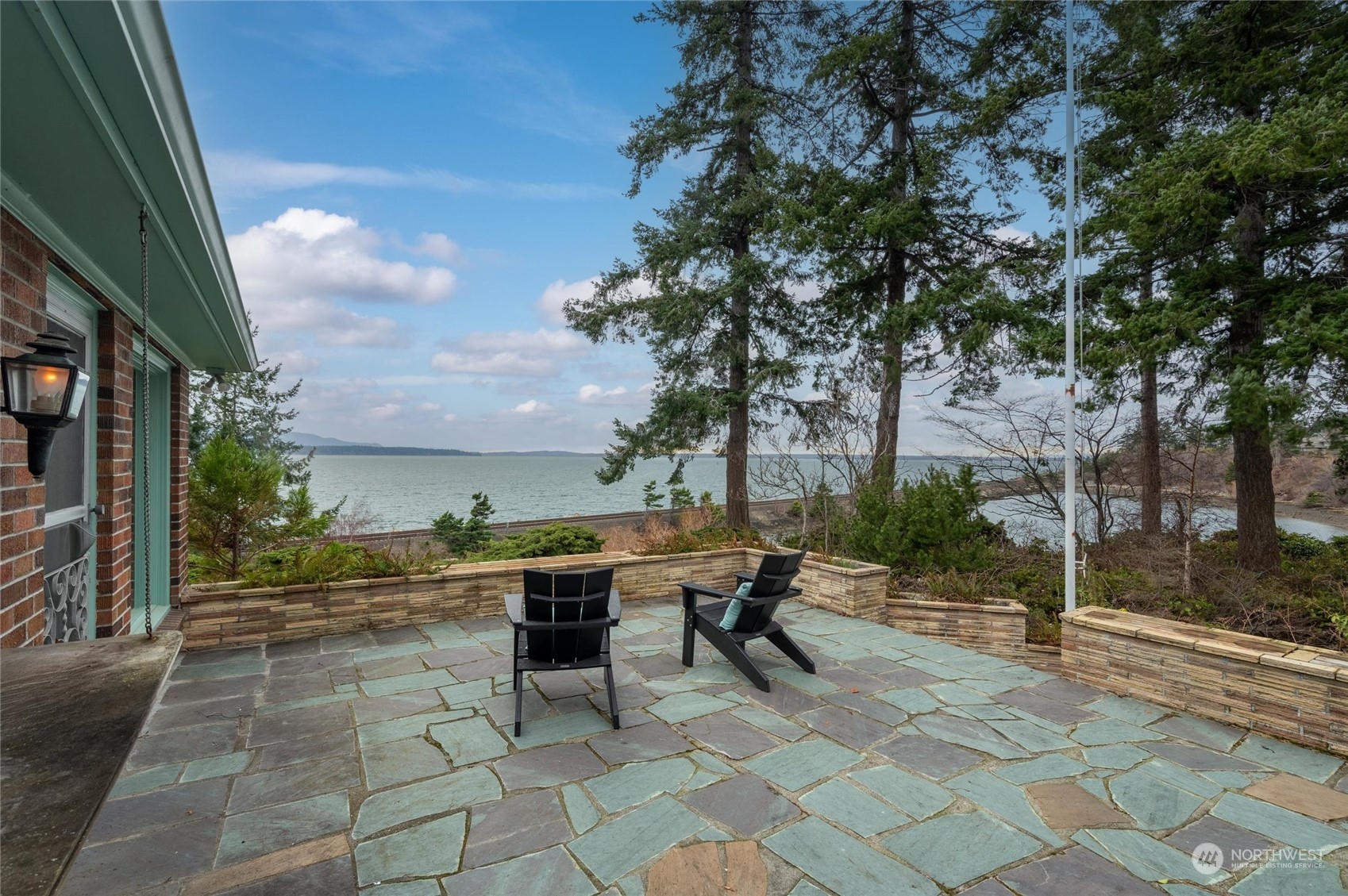 101 Willow Road Bellingham, WA 98225 - Photo 14 of 40 a view of a patio with table and chairs and floor to ceiling window