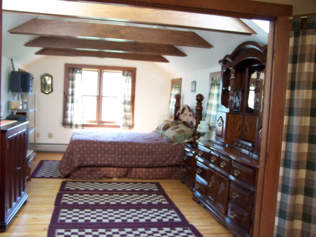 879 Wade Inn Road Becket, MA 01223 - Photo 11 of 29 a bedroom with a bed dresser and a window