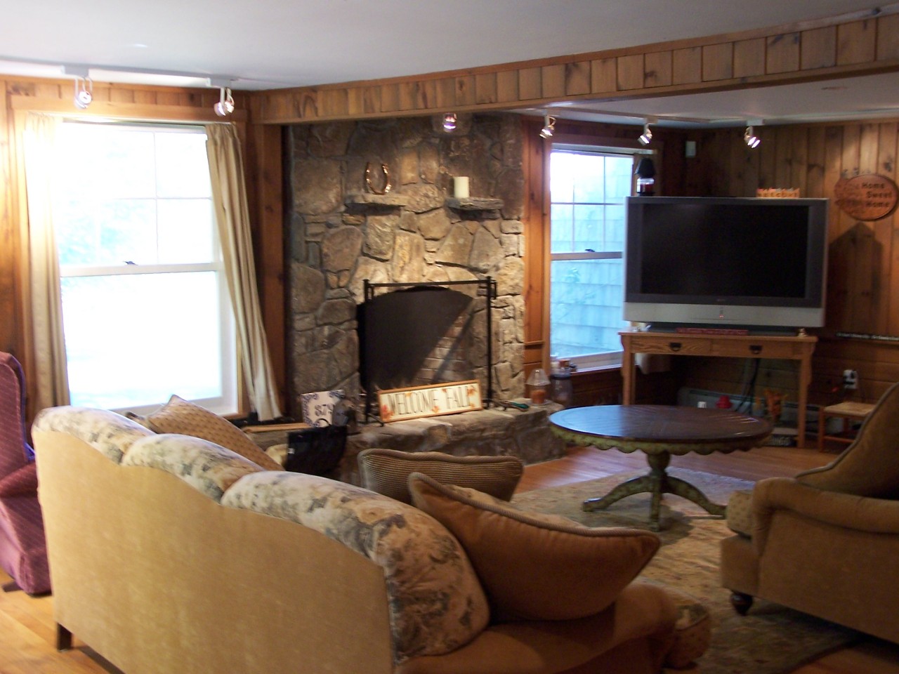 879 Wade Inn Road Becket, MA 01223 - Photo 4 of 29 a living room with fireplace furniture and a flat screen tv