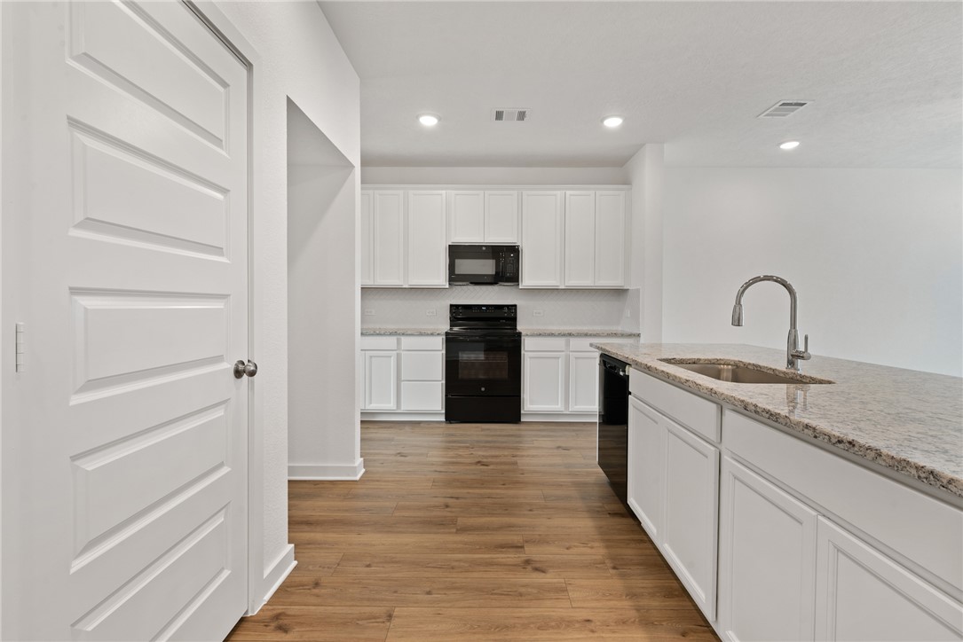 2426 Rooke Road Bryan, TX 77807 - Photo 11 of 39 a kitchen with a refrigerator and a stove top oven