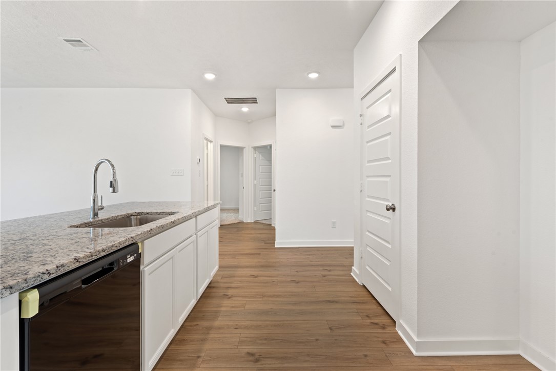 2426 Rooke Road Bryan, TX 77807 - Photo 12 of 39 a kitchen with granite countertop a sink and cabinets