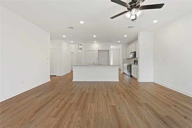 a view of a kitchen with a dishwasher and wooden floor